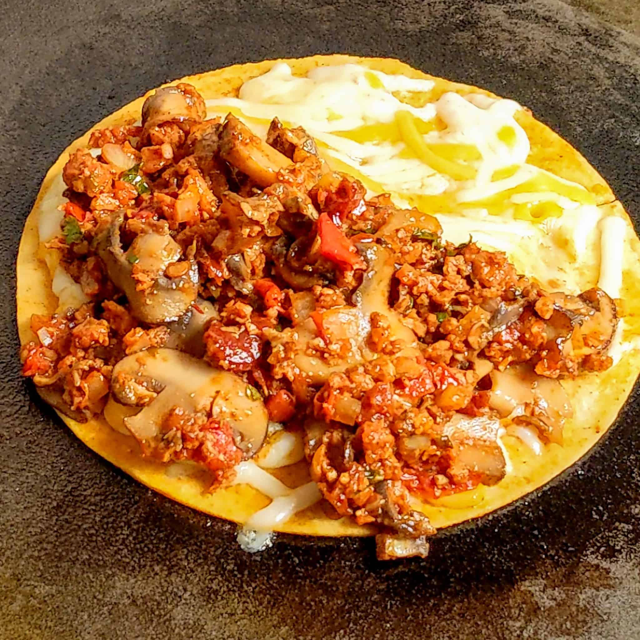 open face Vegetarian Birria Style Taco with melted cheese and filling.
